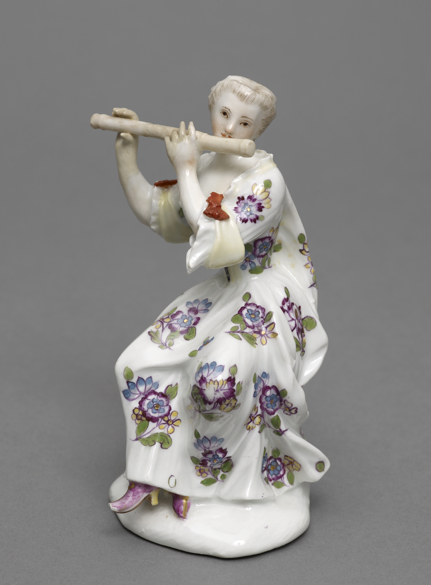 figure of a woman playing a flute
